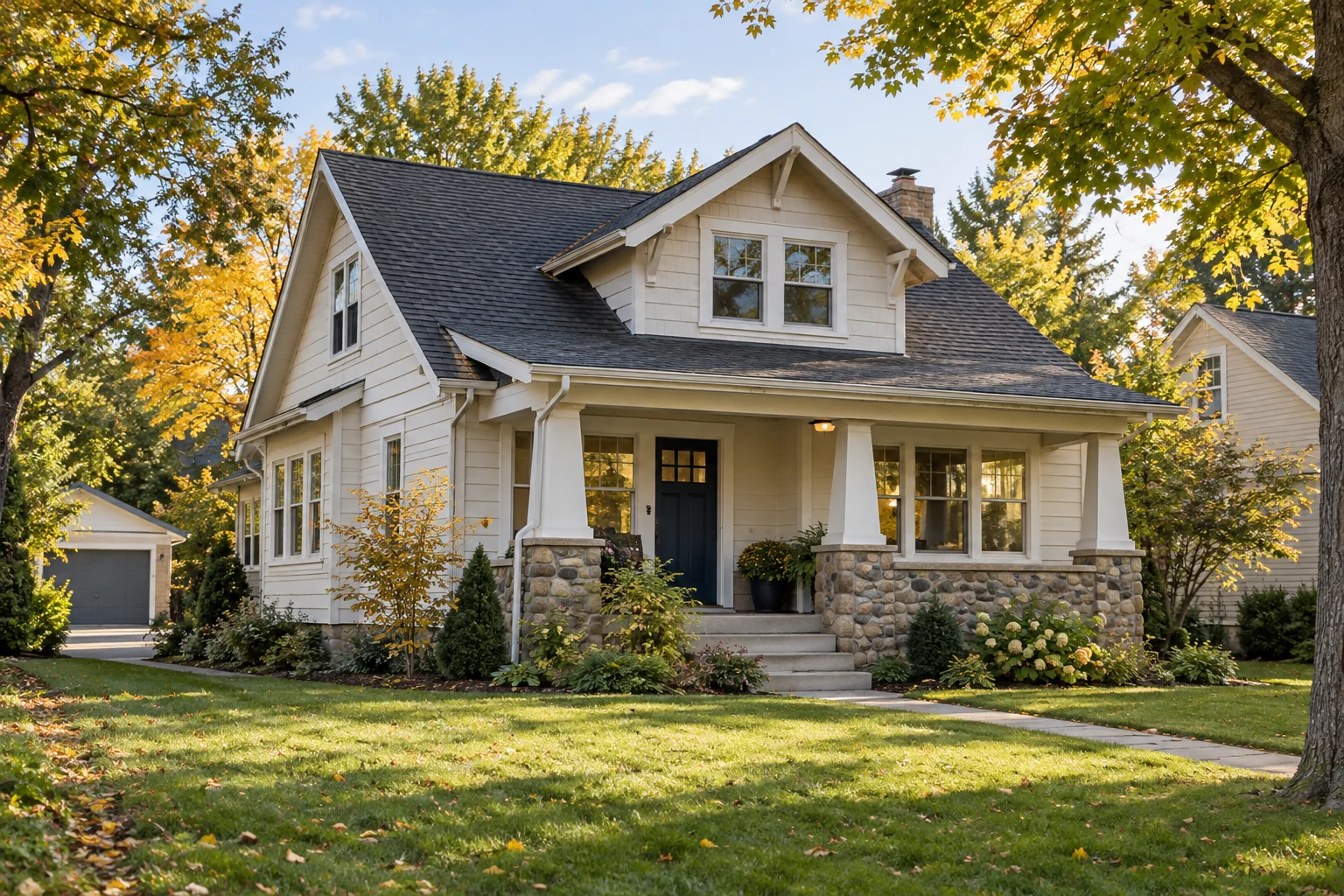 Minnesota-style Craftsman home with a covered porch and autumn trees